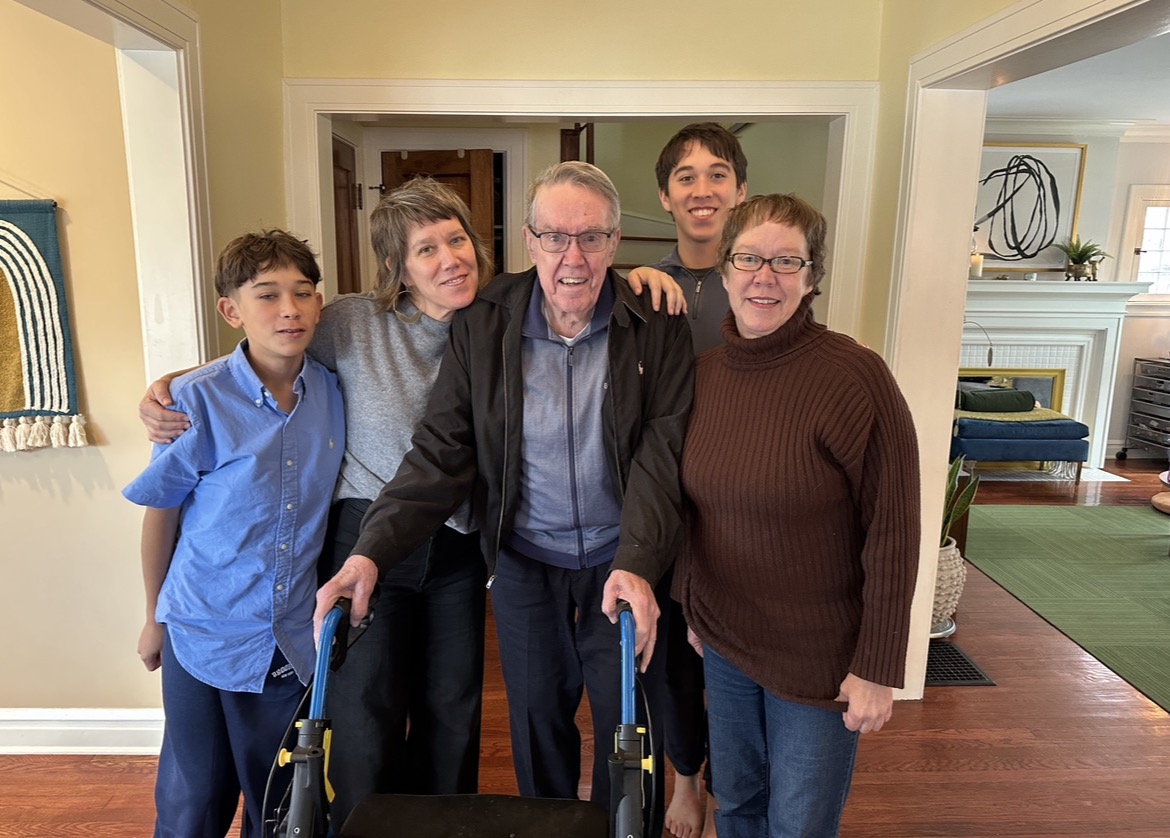Family gathered around Grandpa in the living room