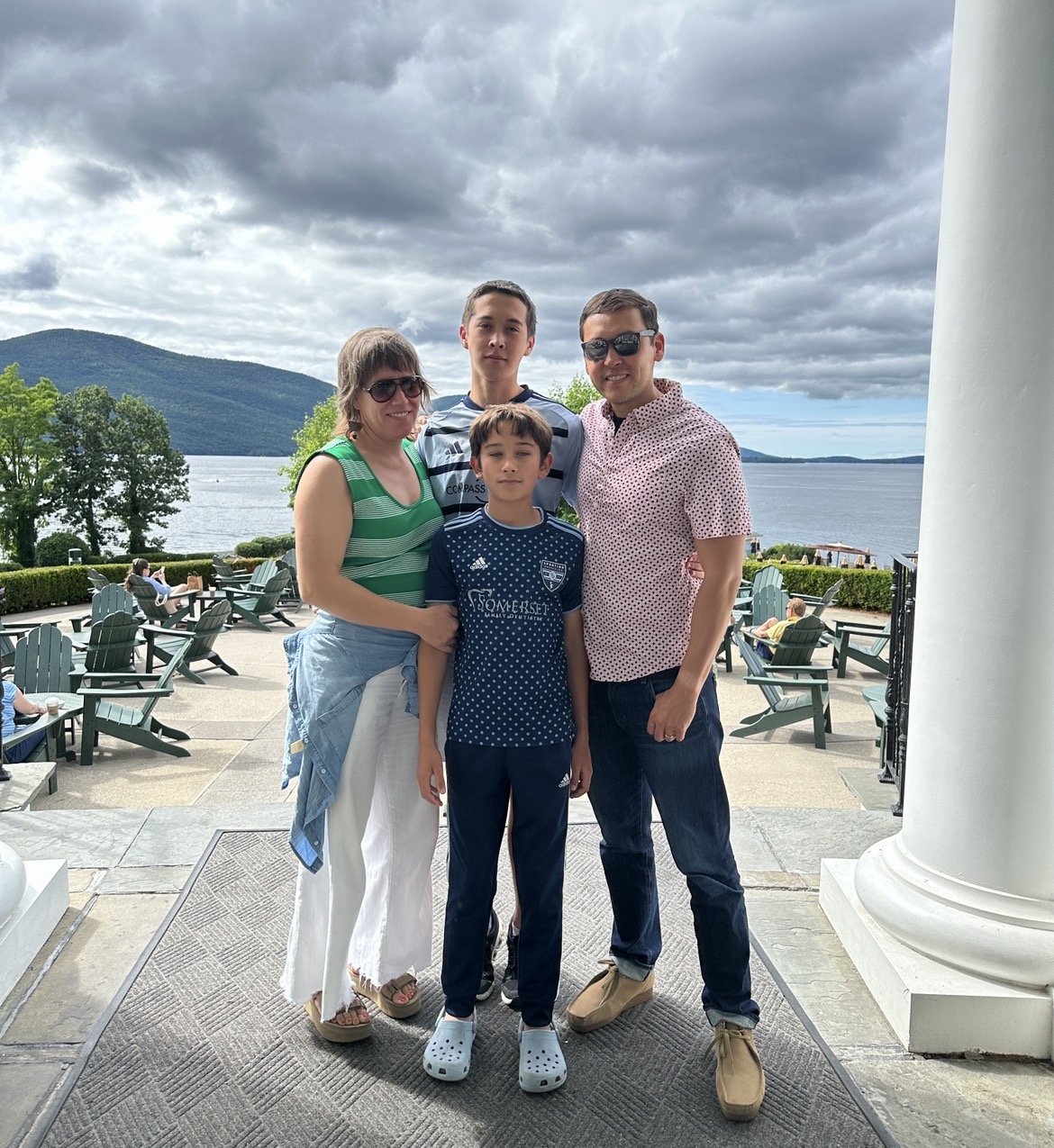 The family of four on a terrace above the lake